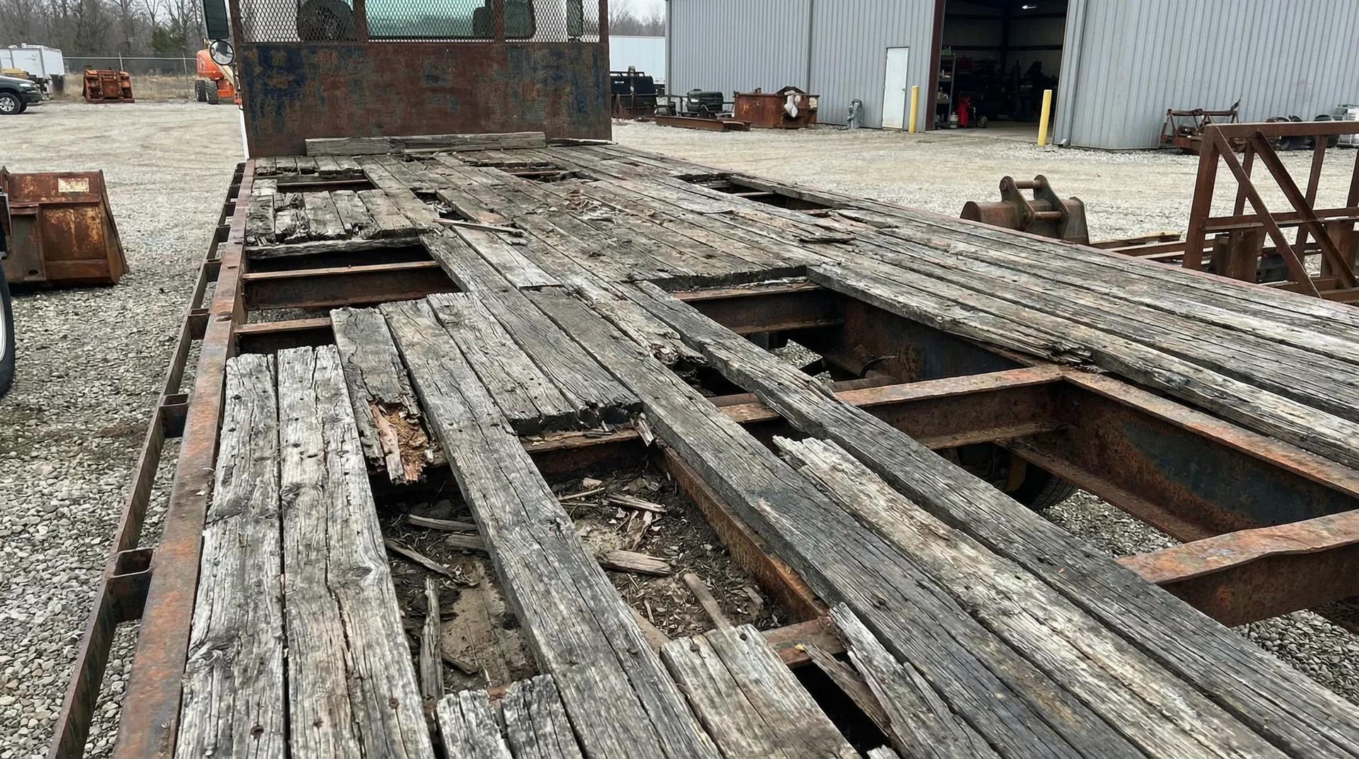 Damaged flatbed deck before repair